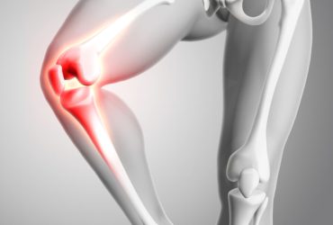 3D render of a medical figure with close up of knee and glowing bones
